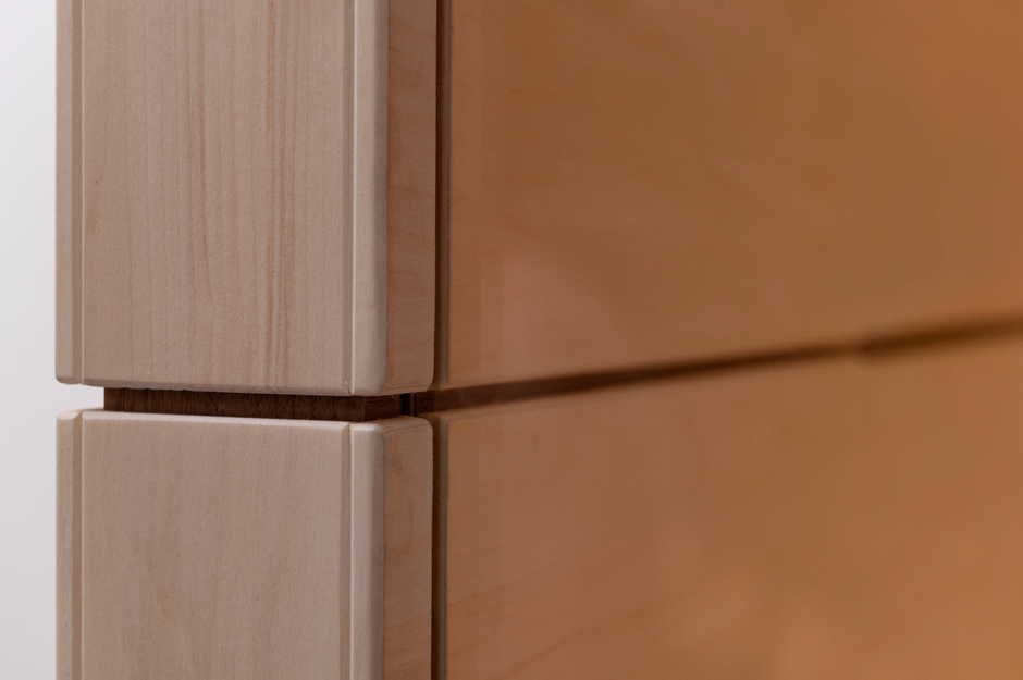 Close-up of wooden paneling with a focus on the joint between two panels.