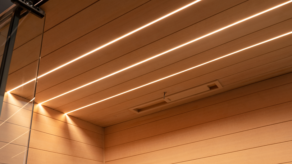 Wooden sauna ceiling with embedded lighting