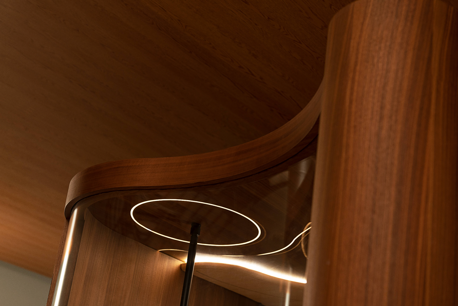 Wooden sauna ceiling with a modern design and circular light feature.