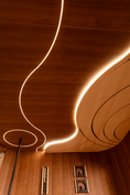 Load image into Gallery viewer, Wooden Sauna ceiling with curved design and embedded lighting, featuring a minimalist decor.
