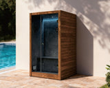 Wooden outdoor steam enclosure next to a pool