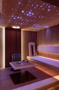 Load image into Gallery viewer, Modern wooden sauna interior with a star-lit ceiling, soft ambient lighting, and built-in heater — featuring a minimalist bench and relaxation setup by Haus of Heat.
