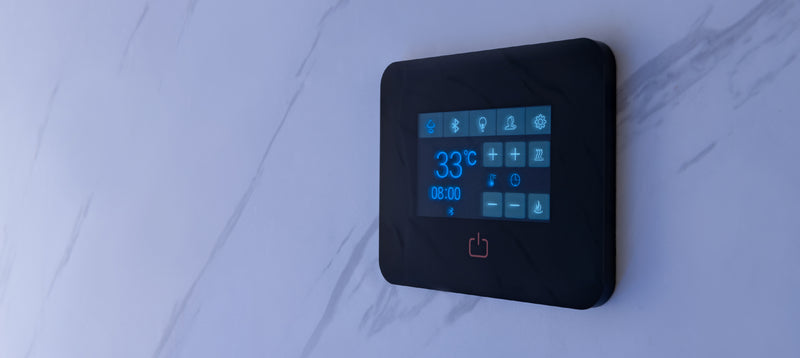 Digital temperature controller on a white marble wall steam room
