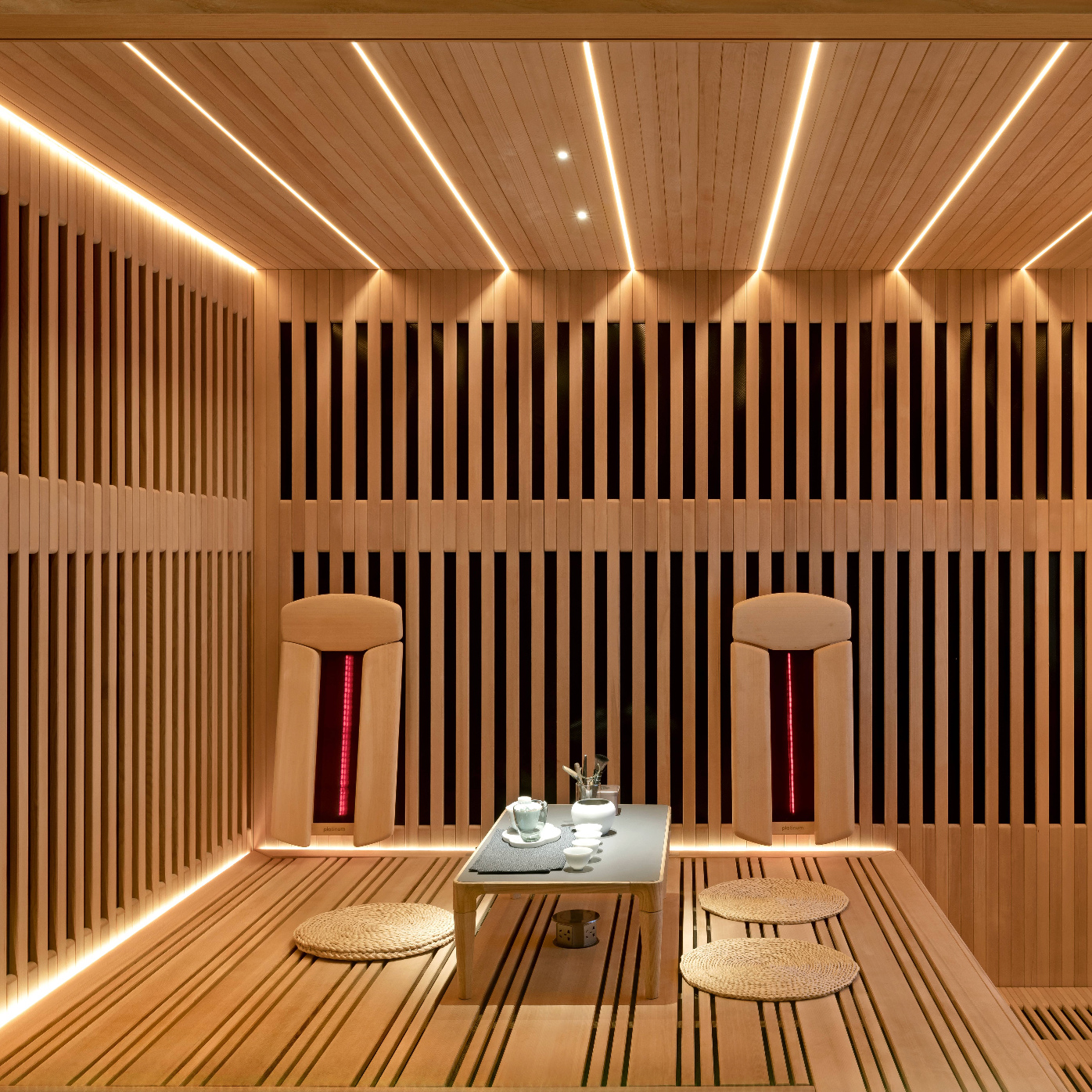 Novo sauna in ash and hemlock wood with grid design and warm lighting.
