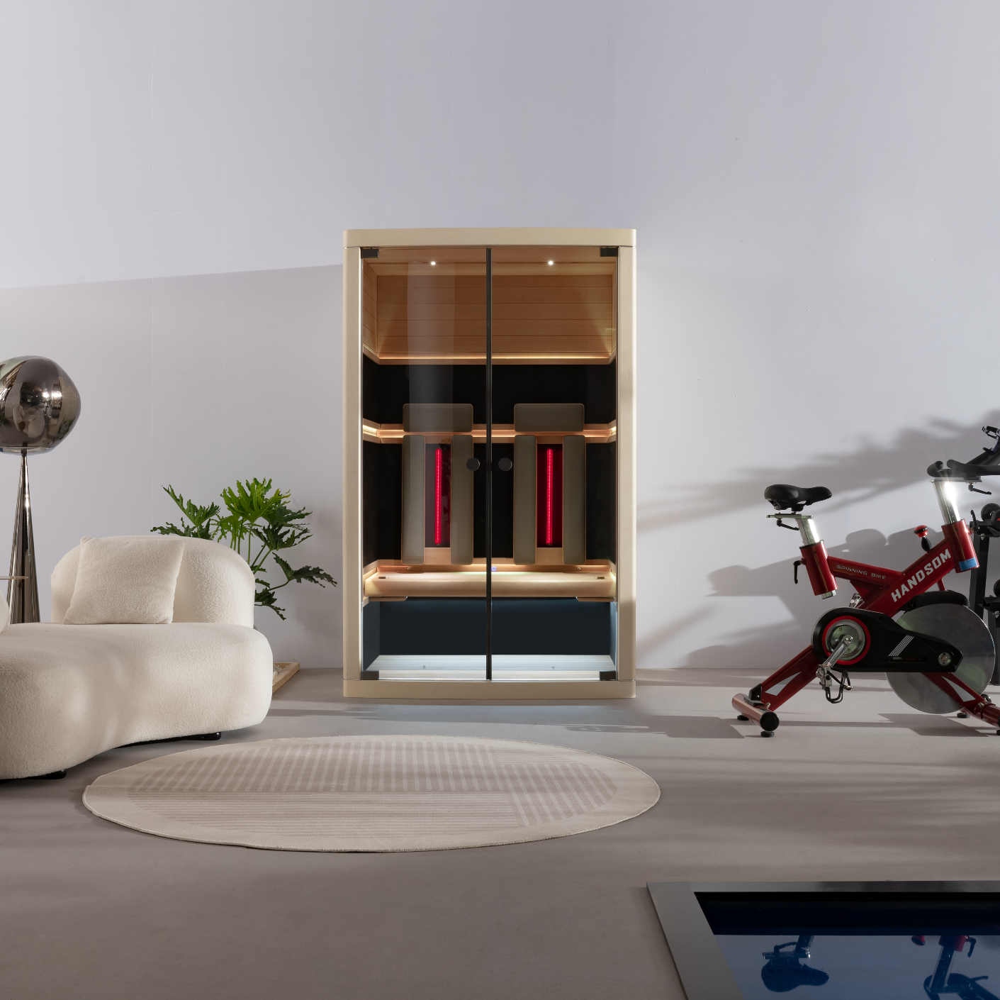 Modern home gym with a stationary bike, dumbbells, and a cabinet.