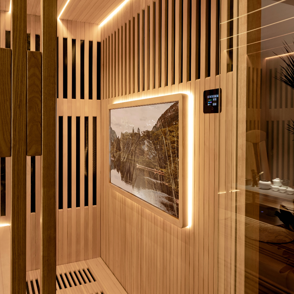 Wooden sauna interior with a digital display and framed picture.