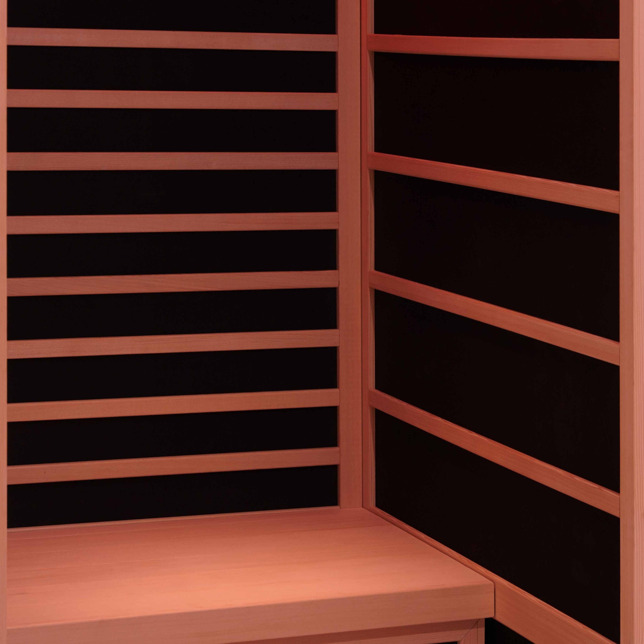 Infrared sauna with wooden benches and black panels