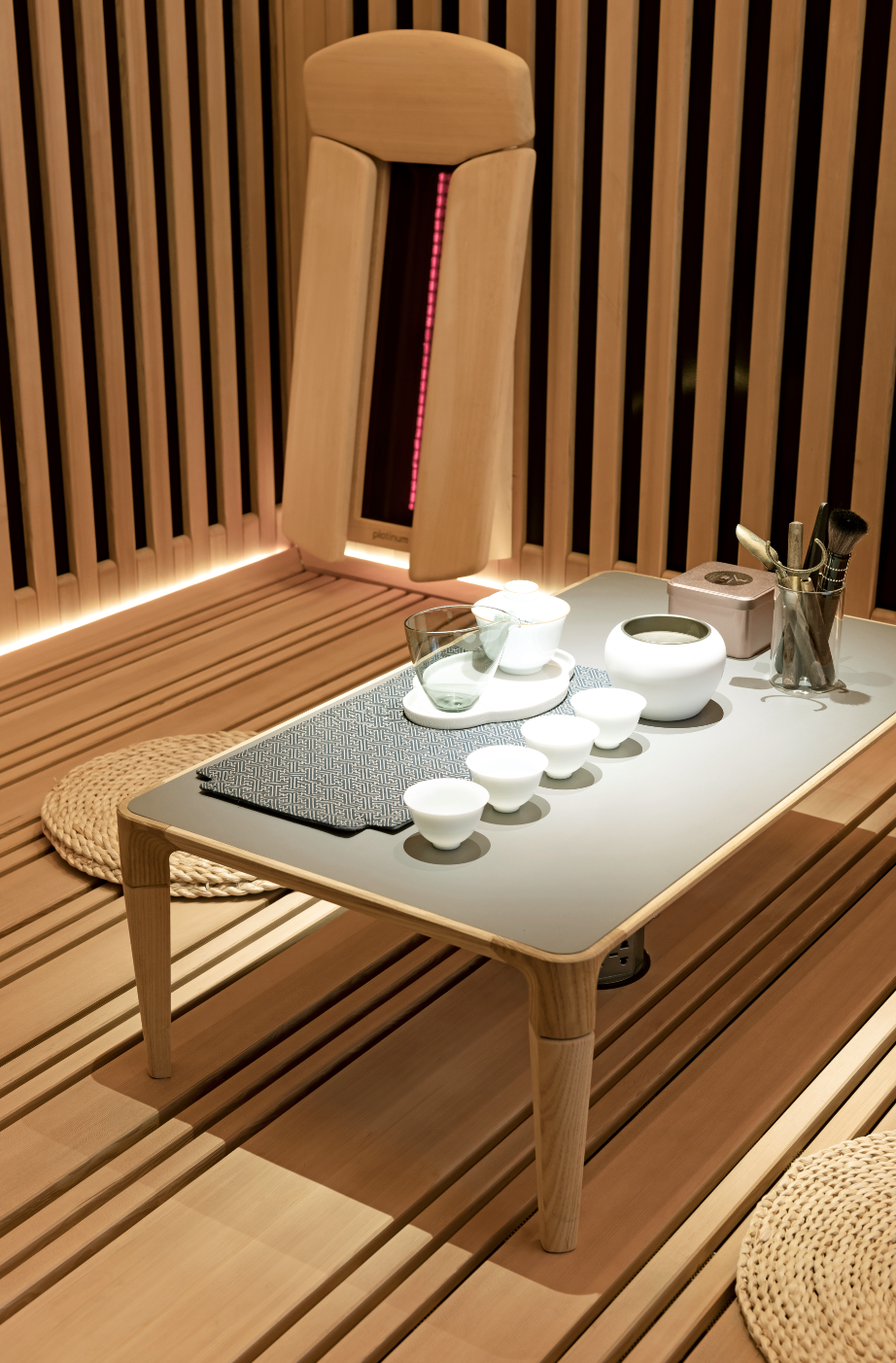 Tea set on a small table in a wooden sauna