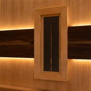 A rectangular bio-therapy band with a light natural wood frame, set against a wood-paneled wall with warm ambient lighting.