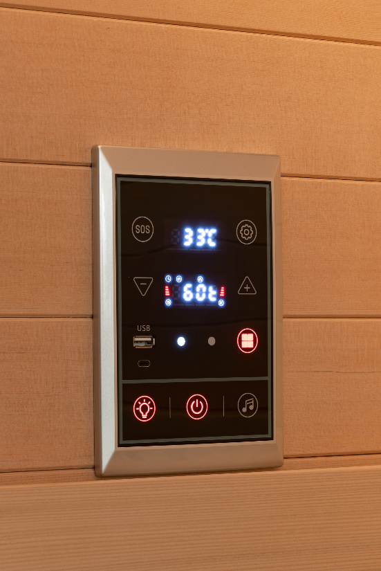 Digital control panel on a wooden wall with sauna lights.
